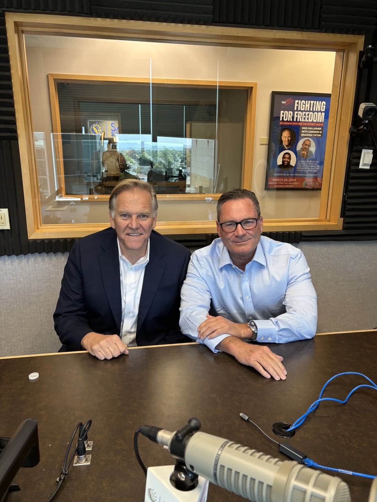 Chuck Warren at the microphone in the Breaking Battlegrounds studio with a guest